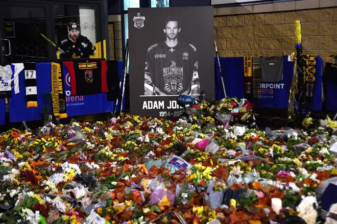 Flower tributes for Nottingham Panthers player Adam Johnson rest outside the Motorpoint Arena before a memorial ice hockey game