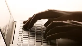 Pair of hands on a laptop