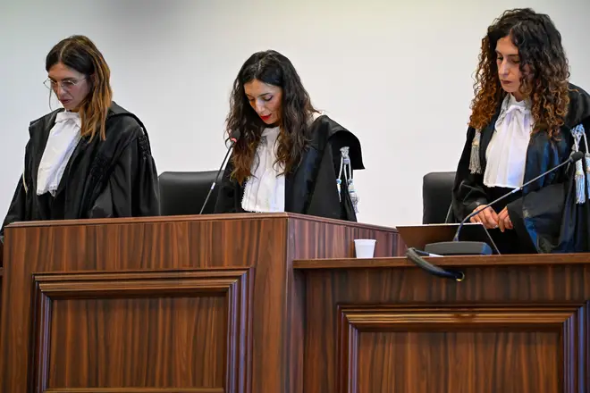 President of the court judge Brigida Cavasino, center, flanked by judges Claudia Caputo, left, and Germana Radice reads the verdicts of a maxi-trial of hundreds of people accused of membership in Italy's 'Ndrangheta