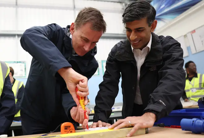 Britain's Prime Minister Rishi Sunak (R) and Britain's Chancellor of the Exchequer Jeremy Hunt