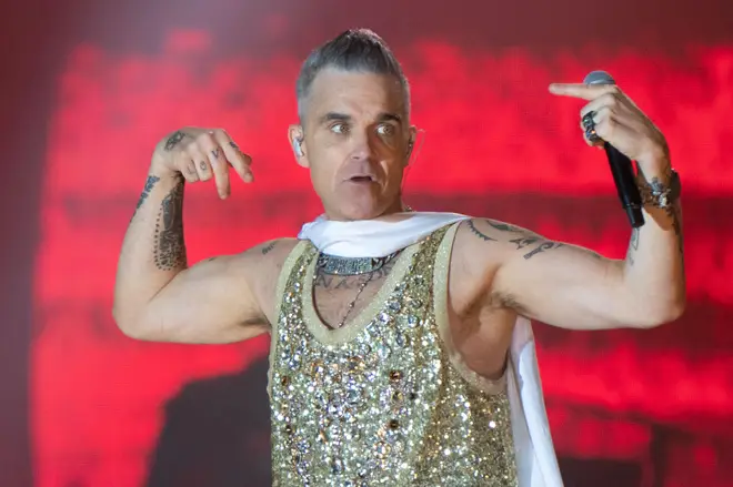 A fan died after suffering a fall at a Robbie Williams concert.
