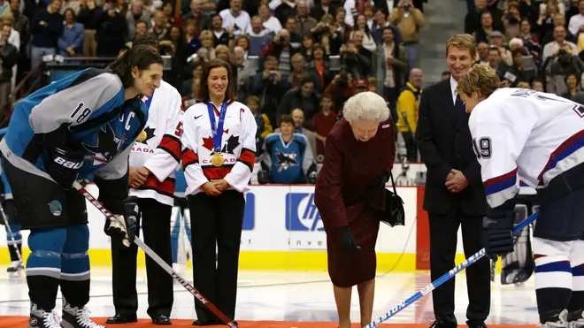 Queen Elizabeth dropping the ceremonial puck prior to the Vancouver Canucks preseason game against the San Jose Sharks 06 October 2002.