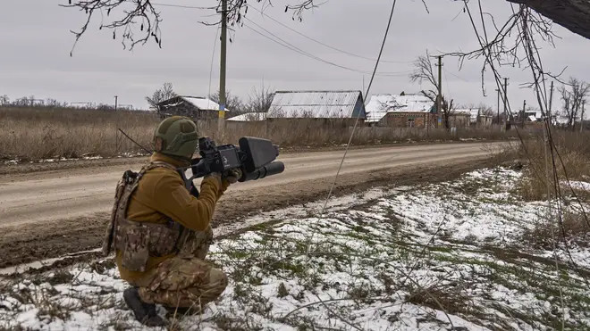 A Ukrainian soldier holds an anti-drone gun near Bakhmut