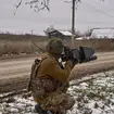 A Ukrainian soldier holds an anti-drone gun near Bakhmut
