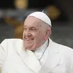 Pope Francis smiles as he waves to crowds