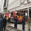 People gather in front of a building in Karachi following a fire