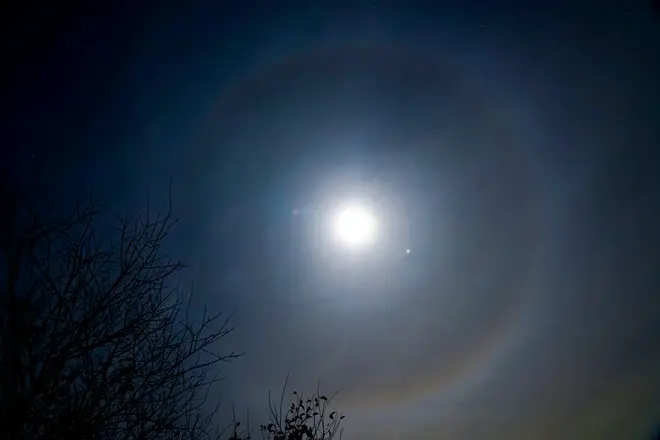 A moon halo, an optical illusion that causes a ring around the moon