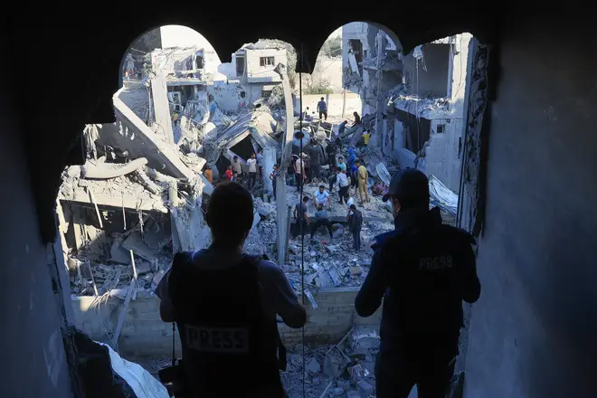 Palestinians inspect their destroyed homes following Israeli bombardment in Rafah in the southern Gaza Strip, on October 18, 2023