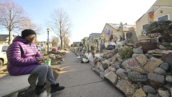 Iris Logan takes a break from dismantling her boulevard rock garden in front of her Sherburne Avenue home in St Paul, Minnesota