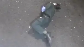 The paramedic rolls on the ground in pain after being pushed out of the ambulance