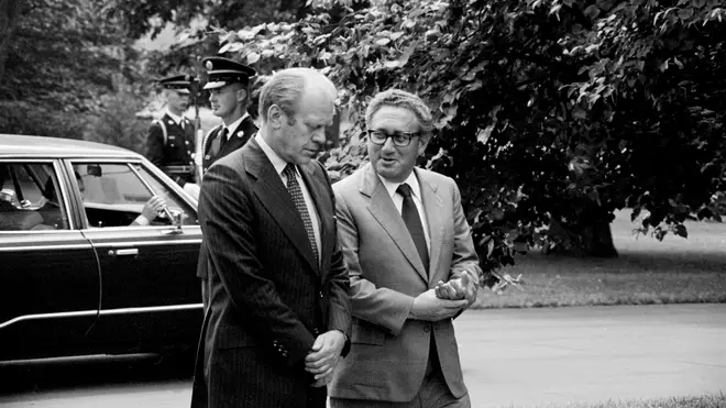 Ford and Kissinger conversing, on grounds of White House, 1974