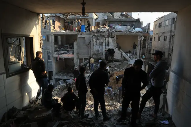Palestinians inspect the destruction around residential buildings following Israeli air strikes in Rafah