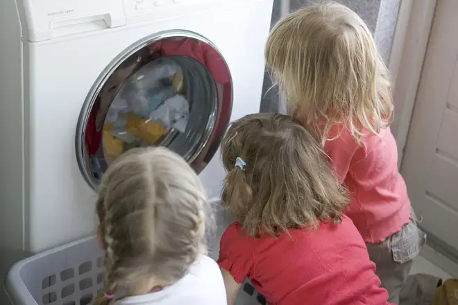 Children look at a washing machine. British Gas customers can get paid to reduce their energy this evening
