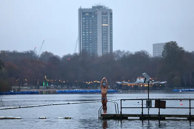 A swimmer braves the icy water at the Serpentine in London