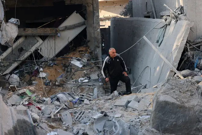 A man stands amid the rubble of a building in the aftermath of an overnight Israeli bombing on Sunday