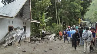 Rescue workers inspect the damage in Simangulampe village