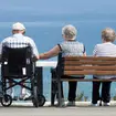 Elderly people at the coast on a warm summer`s day