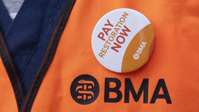 A BMA jacket with a badge saying 'pay restoration now'