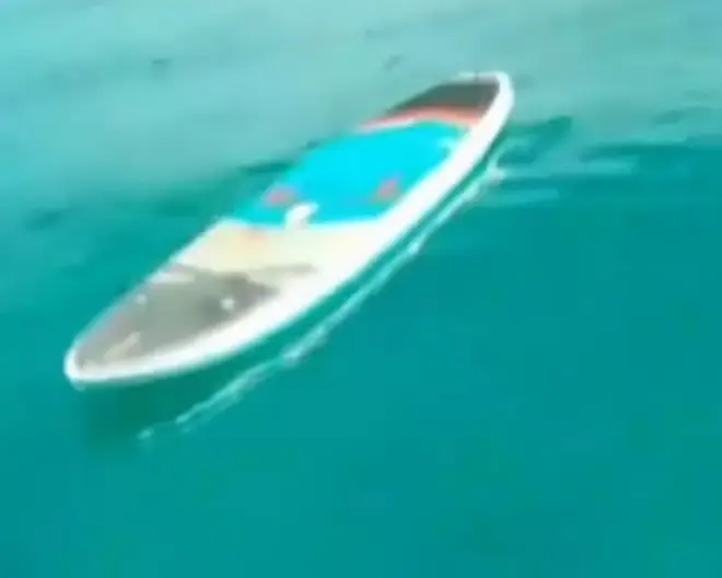 The 44 year-old Boston newlywed's paddle board is pictured floating in the Bahamas on Monday, shortly after she was fatally-mauled by a shark the day after her wedding