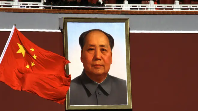Colour photograph of a portrait of Mao Zedong and the Chinese flag