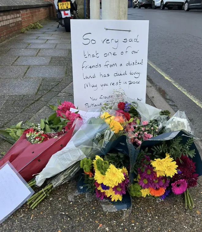 Floral tributes left near the scene after an asylum seeker died on the barge