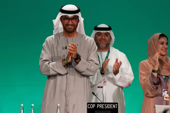 COP28 President Sultan al-Jaber, left, claps after passing the deal
