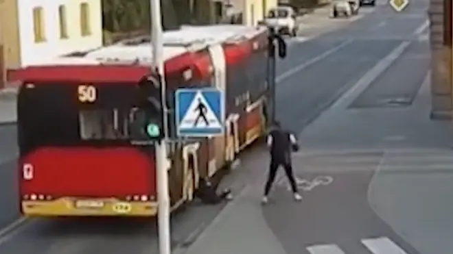 Girl almost pushed under the wheels of a bus by her friend