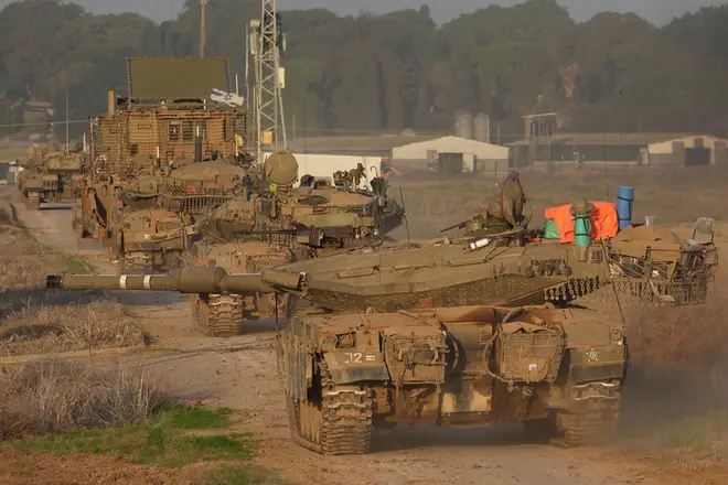 Israeli military tanks roll near the border with the Gaza Strip amid continuing battles between Israel and Hamas, December 3, 2023