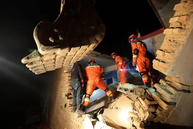 Rescue workers search a collapsed house in a village in Gansu, China