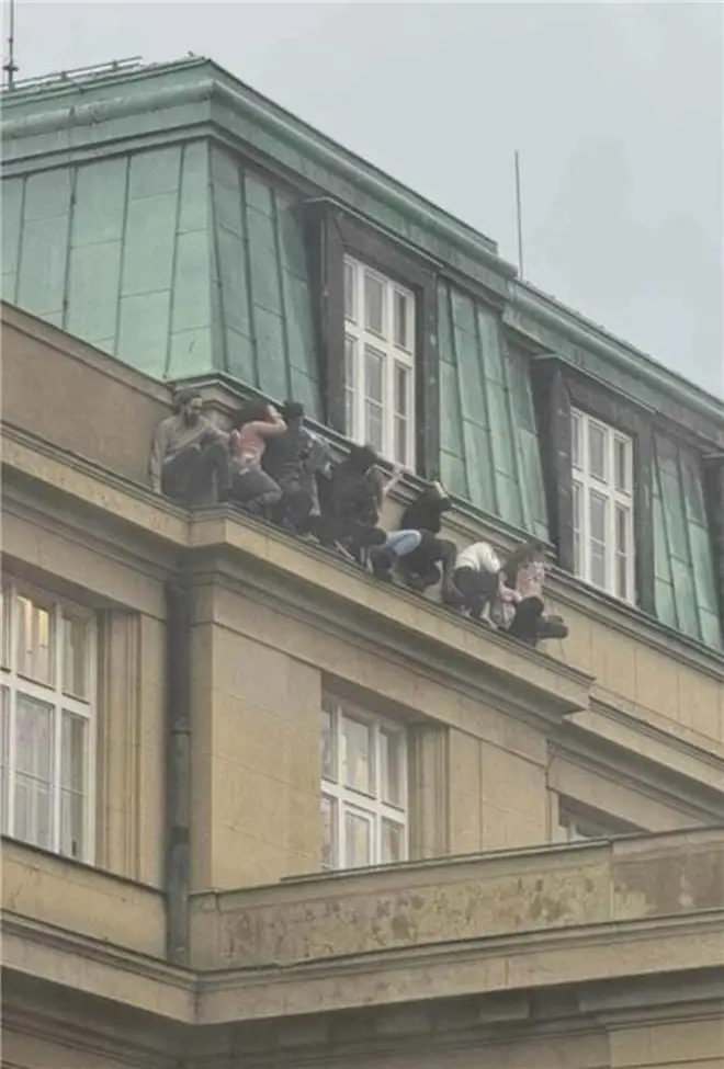 Those inside the building near Jan Palach Square in Prague's Old Town climbed out the windows to flee the gunman