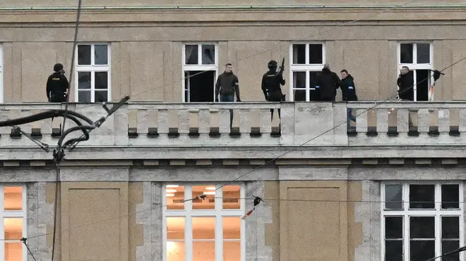 Armed police are seen on the balcony of the Charles University in central Prague, on December 21, 2023