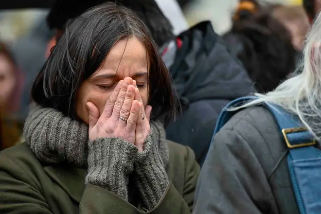 A woman cries outside the headquarters of Charles University after the mass shooting