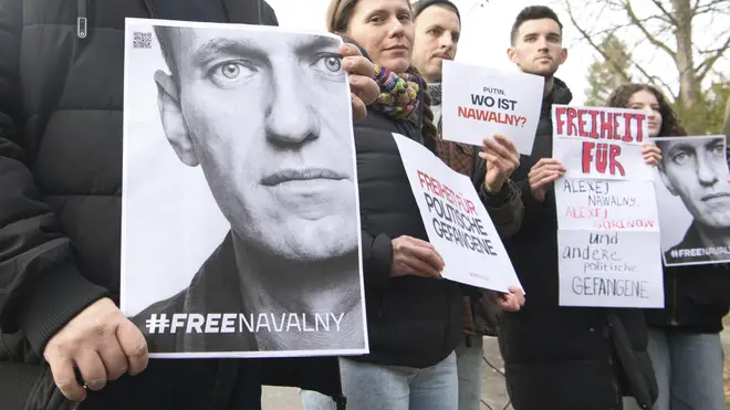 Demonstrators gather outside the home of Russian ambassador Sergei Netshaev in Berlin while contact was lost with Alexei Navalny
