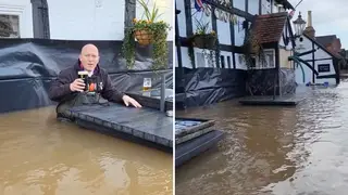 A pub owner has shared a video of him enjoying a pint in flood waters.