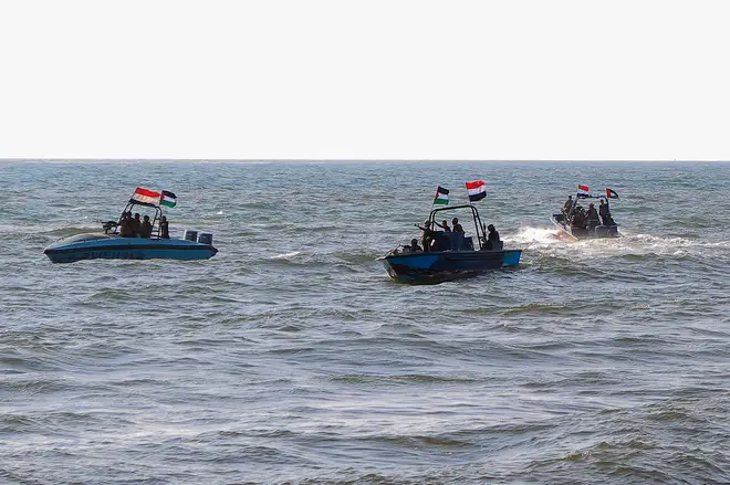 Members of the Yemeni Coast Guard affiliated with the Houthi group patrol the sea as demonstrators march through the Red Sea port city of Hodeida in solidarity with the people of Gaza