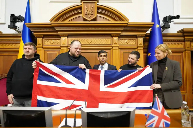 Prime Minister Rishi Sunak (centre) gives a Union Flag to speaker Ruslan Stefanchuk (2nd left) and President Volodymyr Zelensky