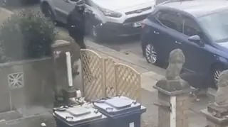 An armed police officer shoots the dog dead