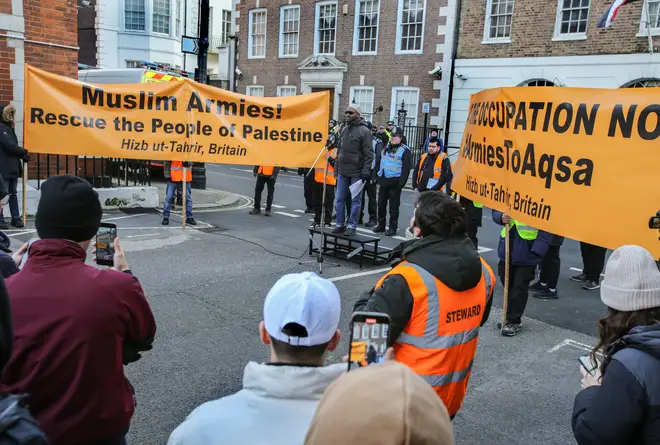 Protesters hold large banners at the front of the protest saying 'Muslim Armies Rescue the People of Palestine' as a speaker addresses the crowd at a Hizb ut-Tahrir protest in November