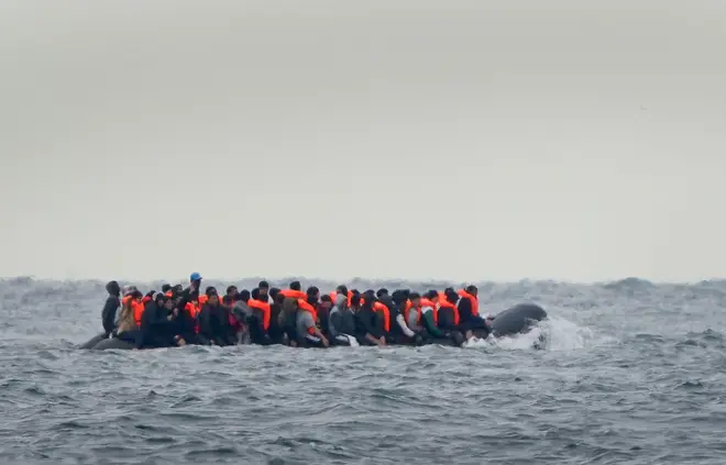 A group of people thought to be migrants crossing the Channel in a small boat traveling from the coast of France and heading in the direction of Dover