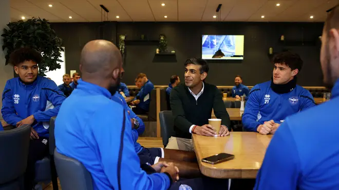 Rishi Sunak talks with players and staff during a visit to Eastleigh FC at Silverlake Stadium
