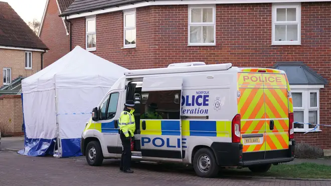 Police outside a house in Costessey near Norwich after four people were found dead inside the property.