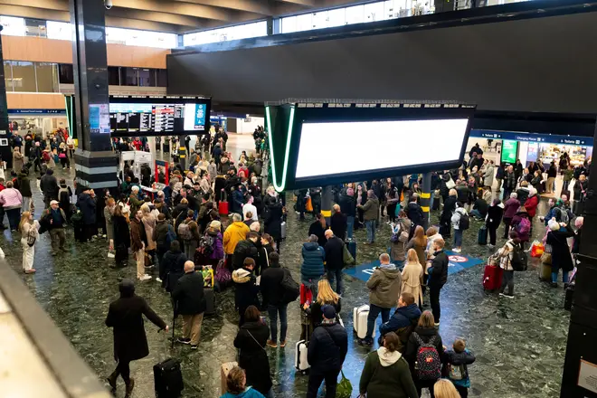 Passengers at Euston station, London, following train delays as Storm Isha has brought severe disruption to rail services