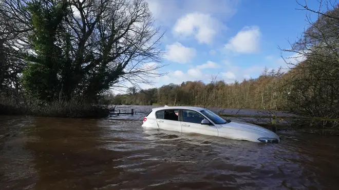 A car stranded in flood water in Warwick bridge in Cumbria as Storm Isha brought disruption to the electricity and transport networks across the UK