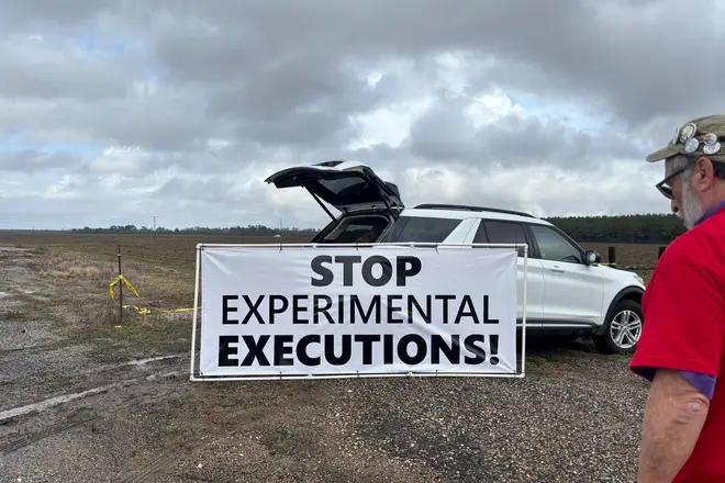 Anti-death penalty activists place signs along the road heading to Holman Correctional Facility in Atmore, Ala., ahead of the execution