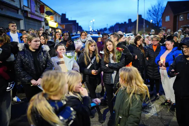 People take part in a vigil near to the scene in south Bristol where two teenage boys, aged 15 and 16, died after a stabbing attack