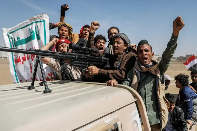 Armed rebels of the Iran-backed Houthi militia ride a pick-up truck during a demonstration against the USA and Israel, January 29