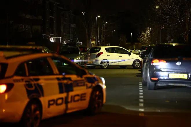 A car is seen behind police cordon after a corrosive substance attack in south London on February 1, 2024.