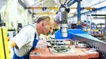 A mechanical engineer works in an industrial factory. Experts suggest the UK pension age could rise to 71