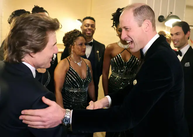 Prince William reacts as he speaks with Tom Cruise at the London Air Ambulance Charity Gala Dinner, Wednesday night