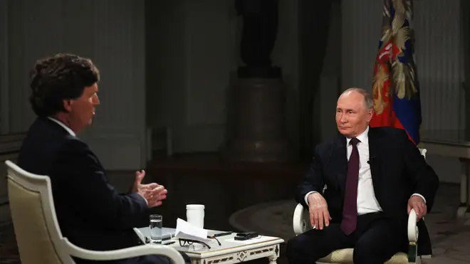 Russian President Vladimir Putin attends an interview with former Fox News host Tucker Carlson